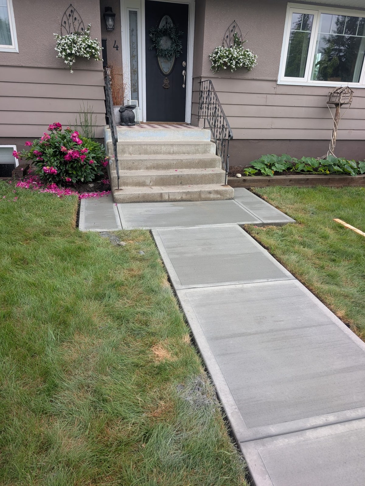 Finished concrete sidewalk and entrance landing